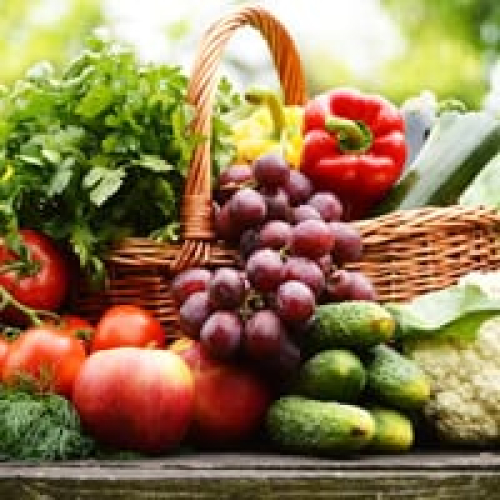 Colorful fresh vegetables and fruits in a basket for healthy diet.
